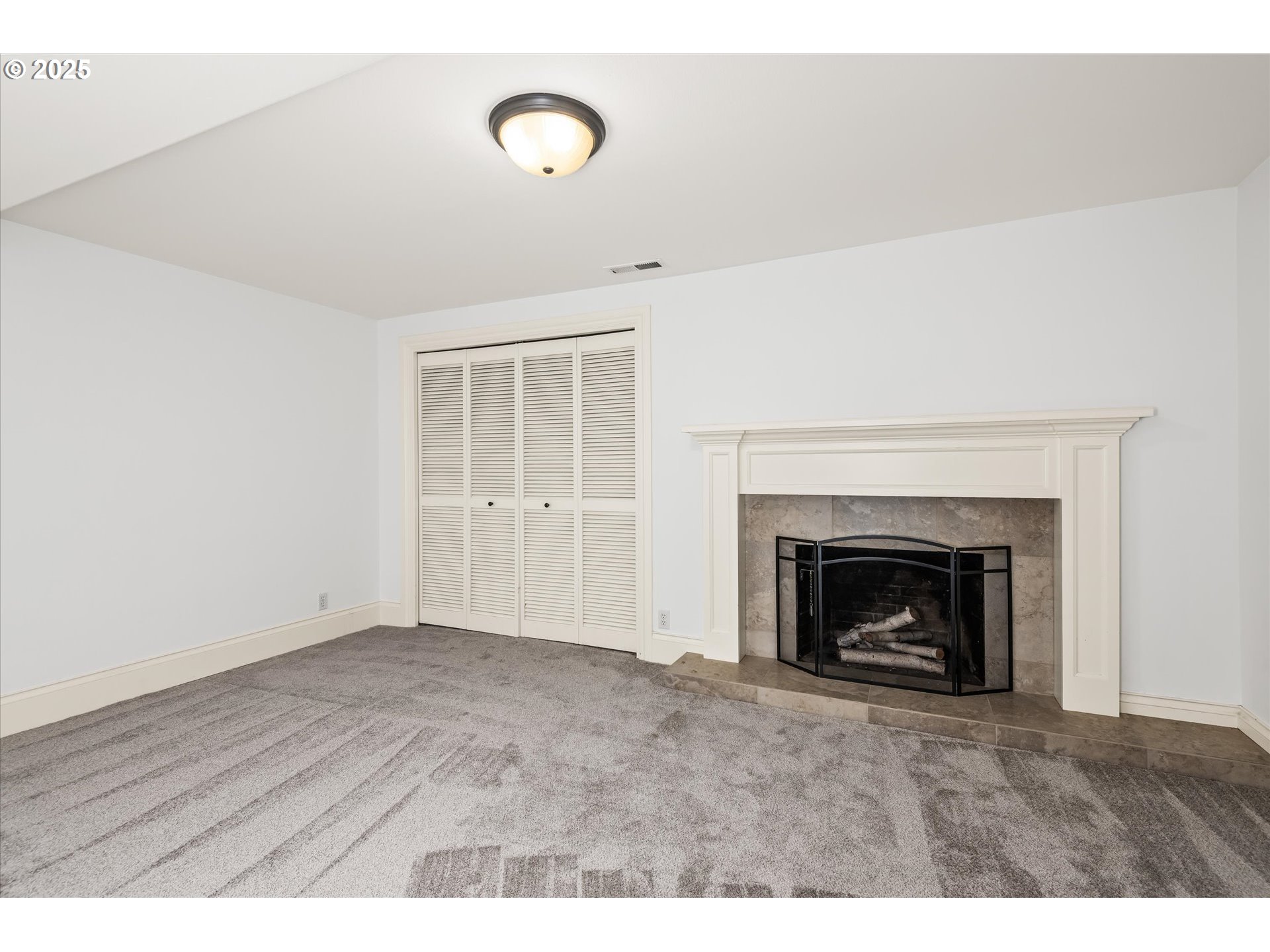 1705 Fairmount Boulevard Eugene, OR 97403 - Photo 33 of 48 a view of an empty room with wooden floor fireplace and a window