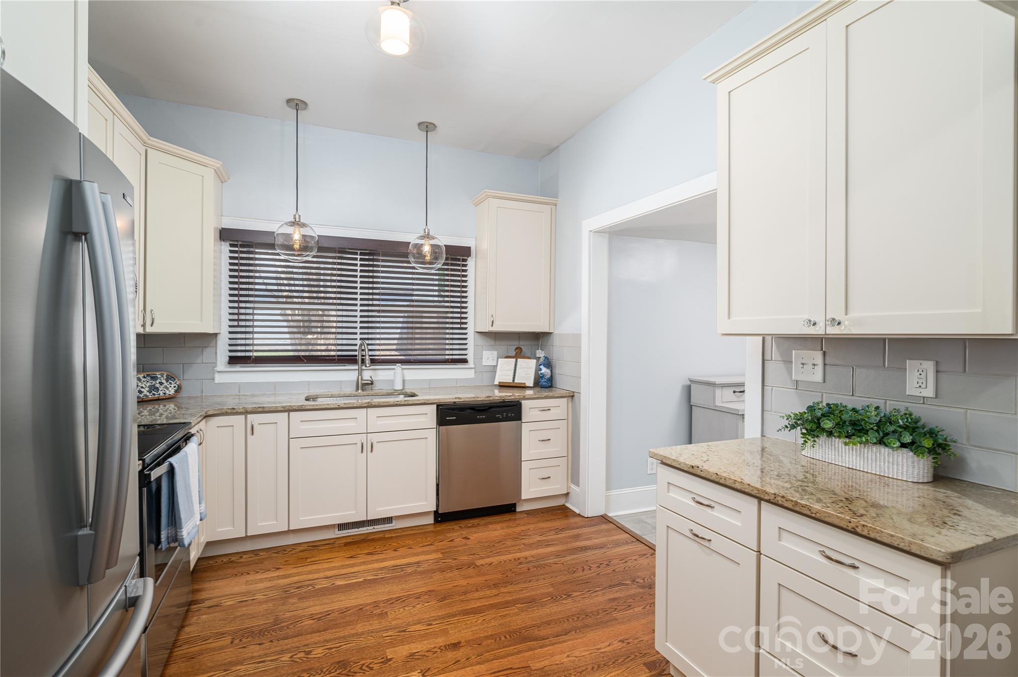 58 Fourth Street Cramerton, NC 28032 - Photo 22 of 44 a kitchen with stainless steel appliances granite countertop a sink stove and refrigerator