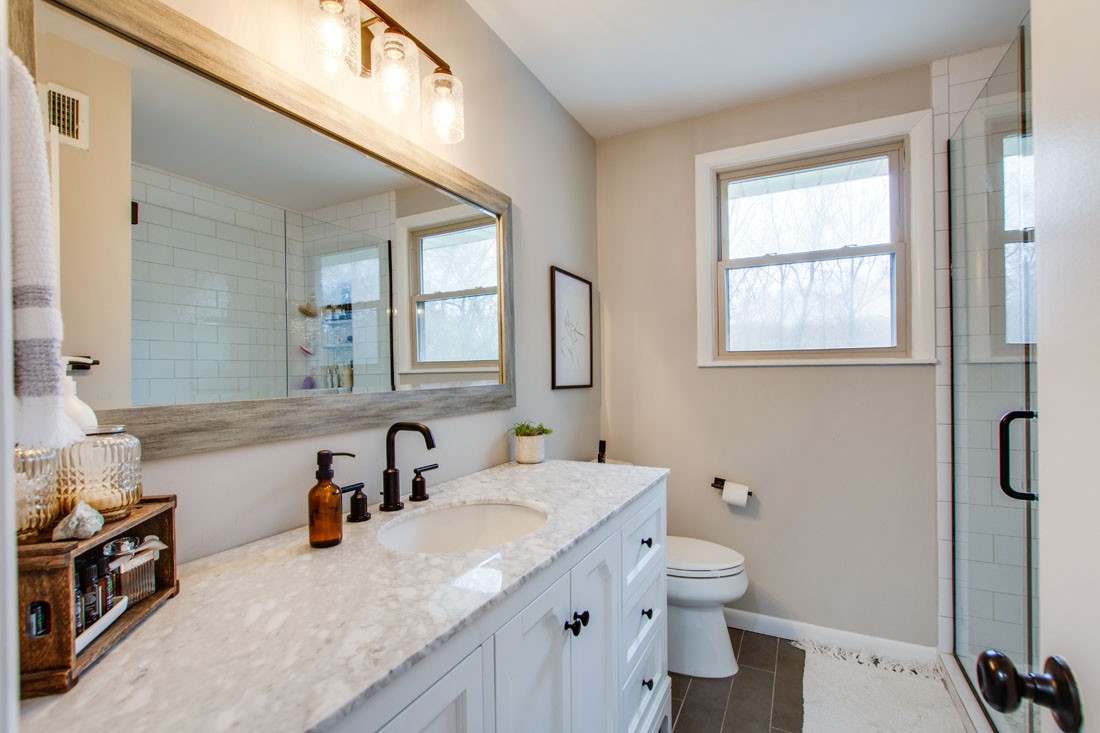 121 Jacksonian Drive Hermitage, TN 37076 - Photo 19 of 28 a bathroom with a granite countertop sink a toilet and a mirror
