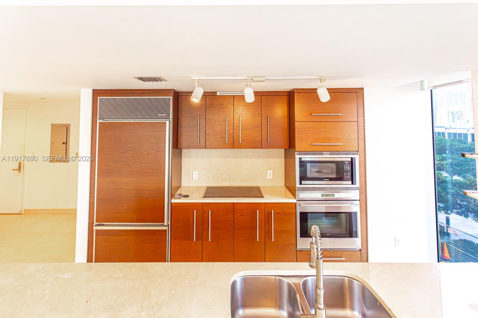 475 Brickell Avenue, Unit 1615 Miami, FL 33131 - Photo 11 of 19 a kitchen with stainless steel appliances granite countertop a refrigerator and a sink