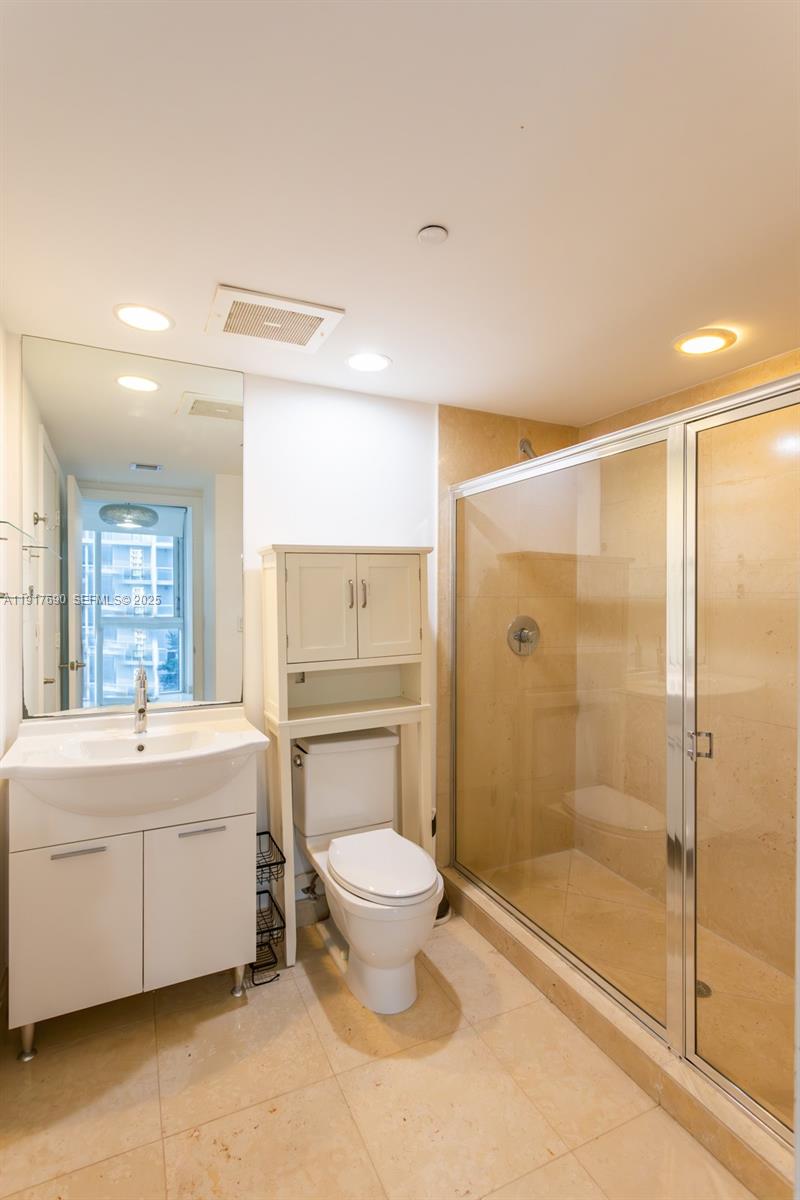 475 Brickell Avenue, Unit 1615 Miami, FL 33131 - Photo 14 of 19 a bathroom with a double vanity sink toilet and shower