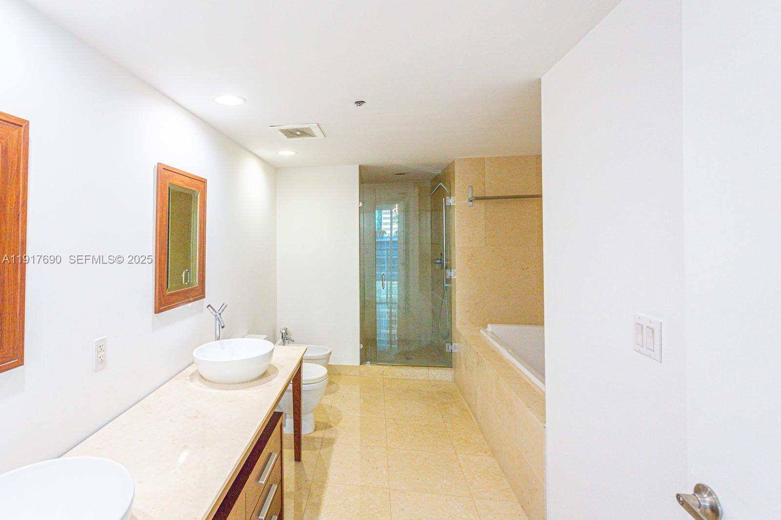 475 Brickell Avenue, Unit 1615 Miami, FL 33131 - Photo 7 of 19 a spacious bathroom with a granite countertop sink a toilet and shower