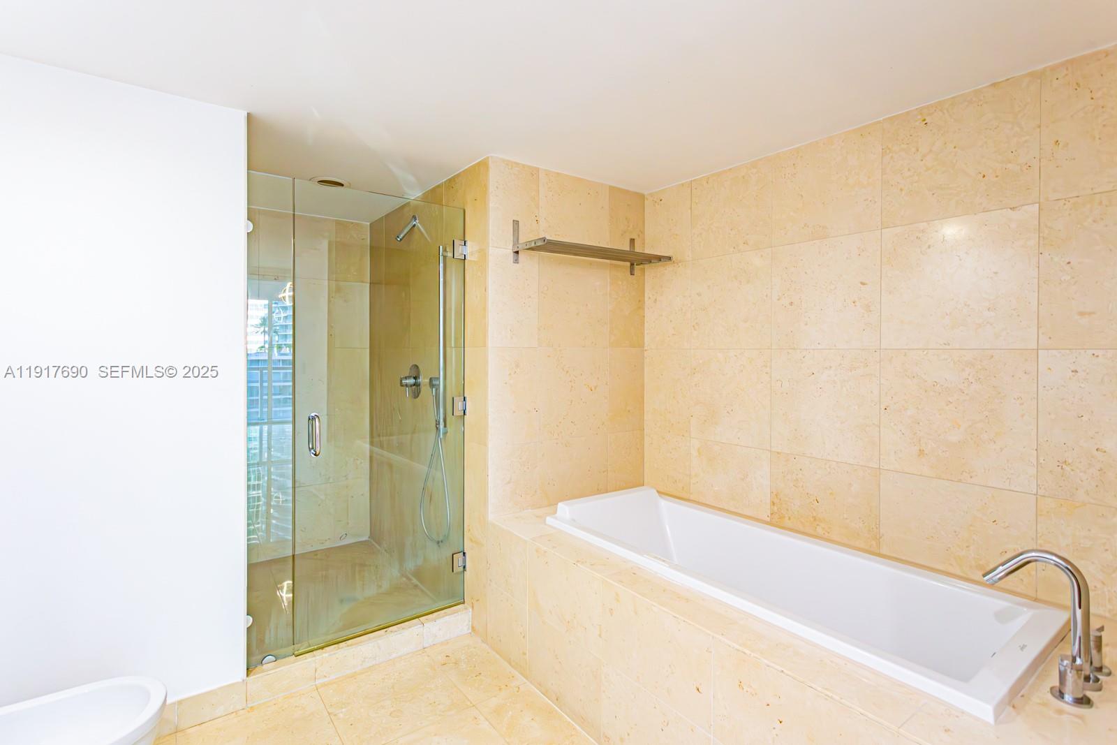 475 Brickell Avenue, Unit 1615 Miami, FL 33131 - Photo 8 of 19 a bathroom with a bathtub and shower