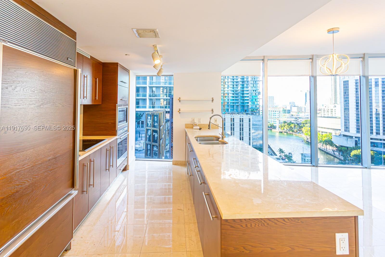 475 Brickell Avenue, Unit 1615 Miami, FL 33131 - Photo 10 of 19 a view of kitchen with furniture and large window