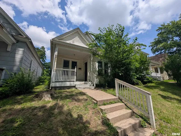 a view of house with outdoor space and garden