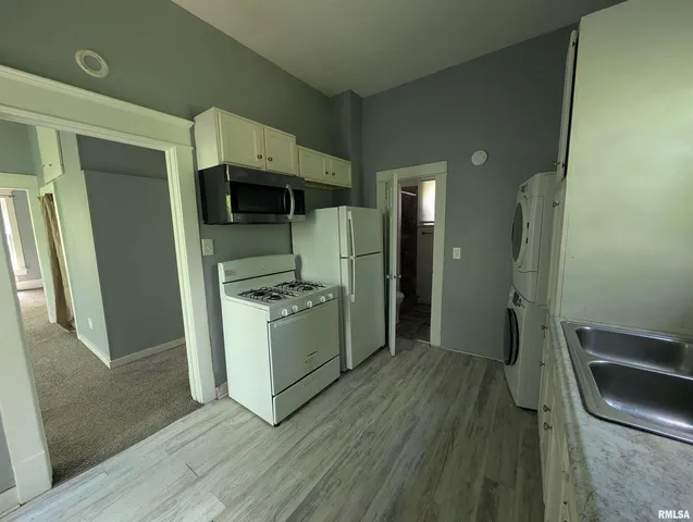 a room with a washing machine and a sink