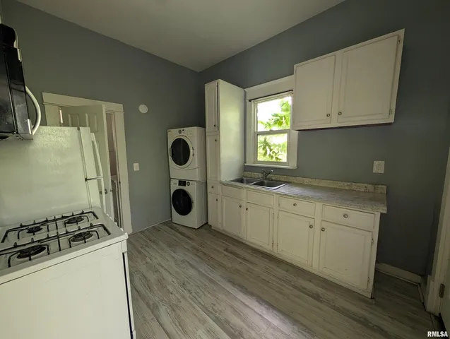 a kitchen with stainless steel appliances white cabinets and a refrigerator