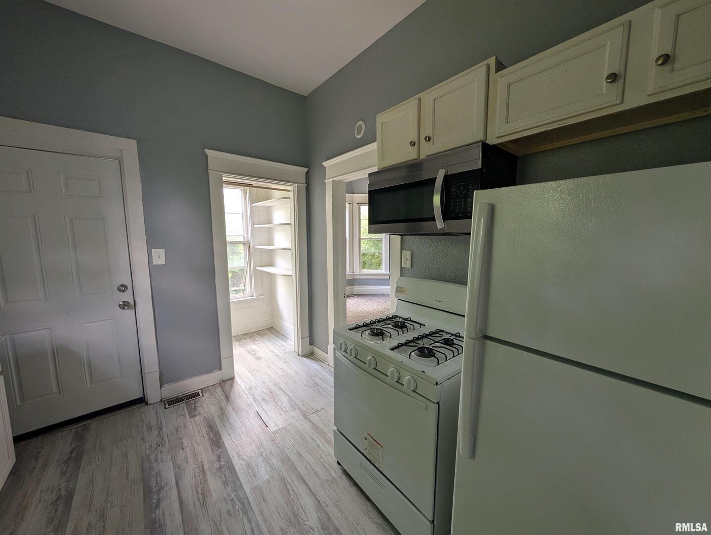 2833 8th Avenue Rock Island, IL 61201 - Photo 16 of 21 a kitchen with stainless steel appliances white cabinets and a refrigerator