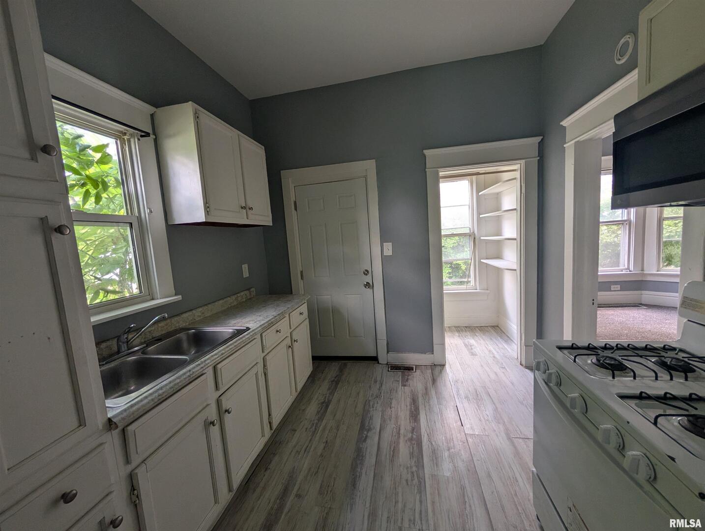 2833 8th Avenue Rock Island, IL 61201 - Photo 17 of 21 a kitchen with wooden floors and appliances