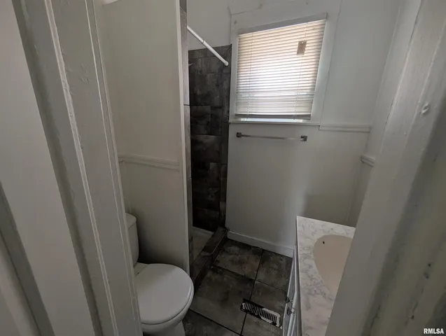 a view of a green field with trees in the background