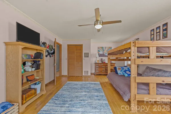 a bedroom with furniture and a large window