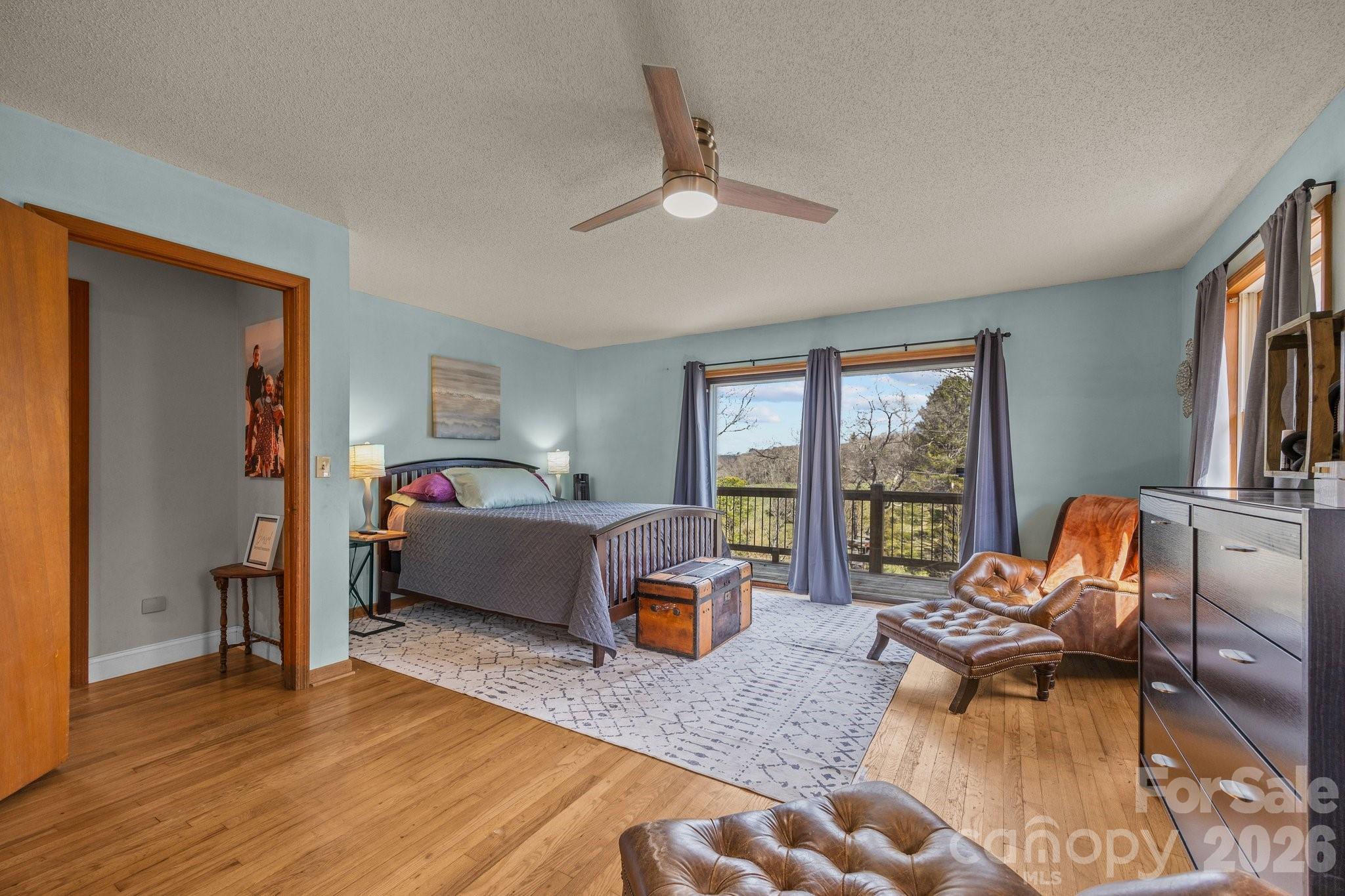 774 Belleview Road Franklin, NC 28734 - Photo 13 of 36 a bedroom with furniture and a large window