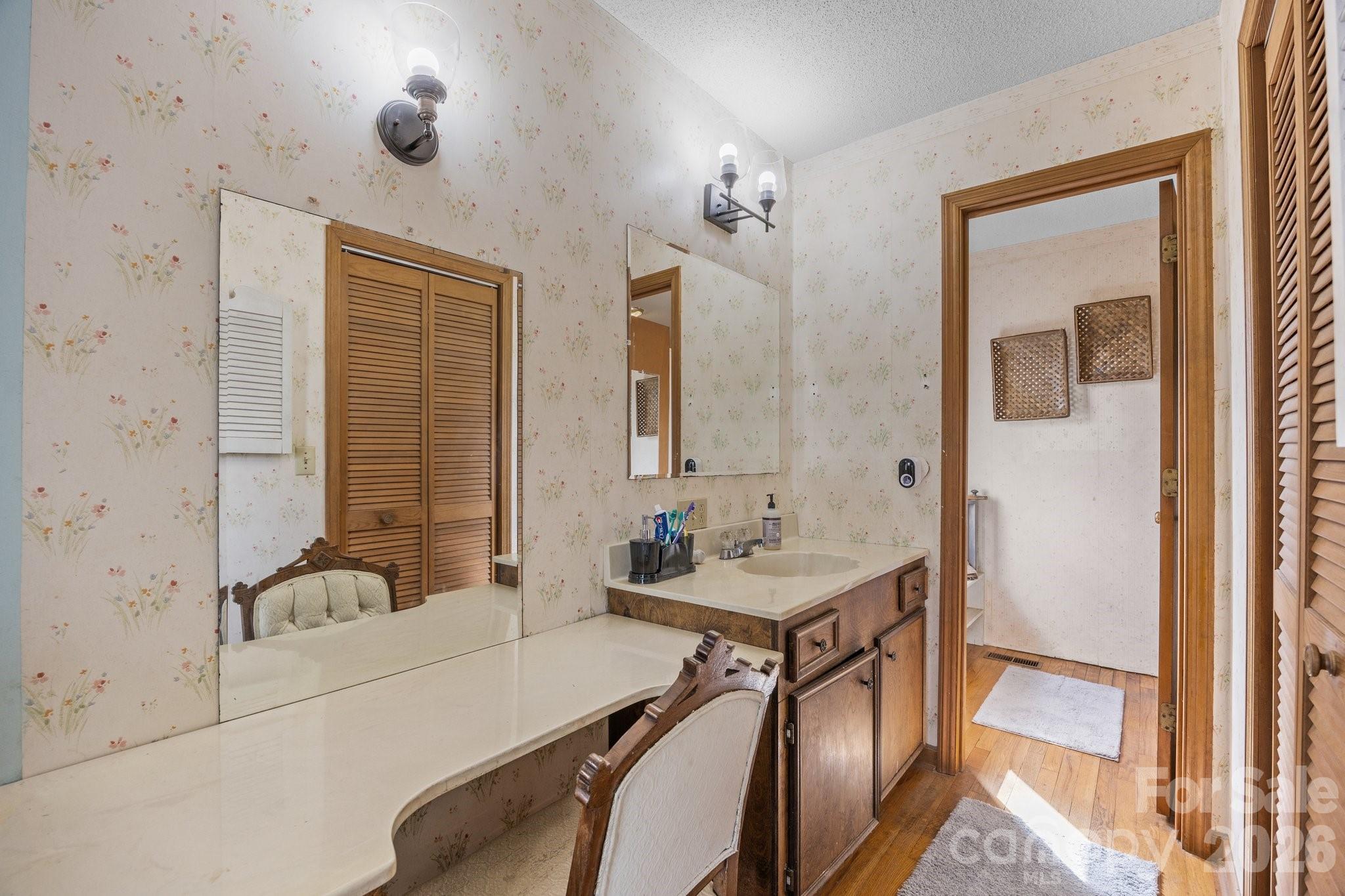 774 Belleview Road Franklin, NC 28734 - Photo 15 of 36 a en suite bathroom with a double vanity sink a mirror and a shower