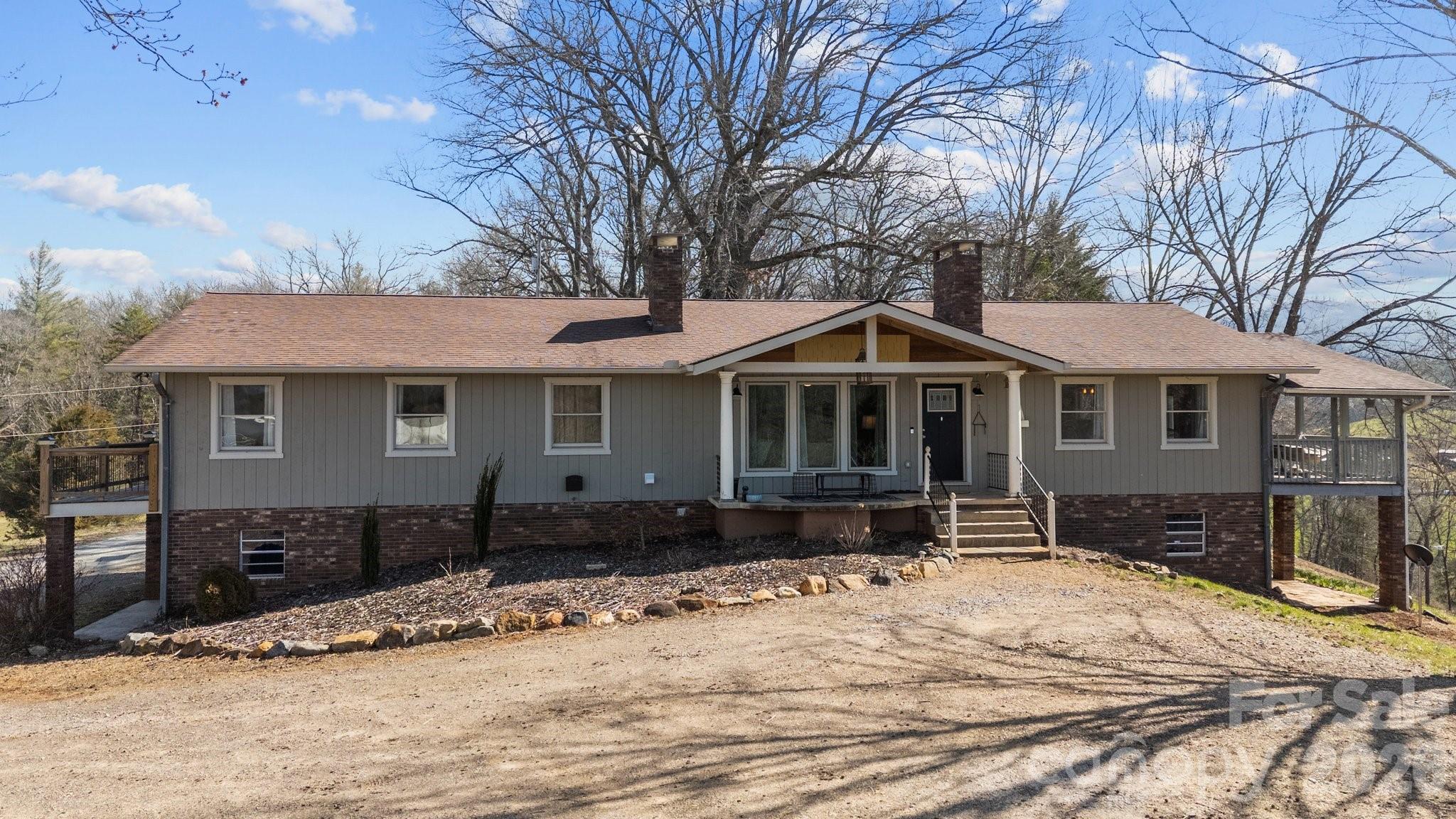 774 Belleview Road Franklin, NC 28734 - Photo 2 of 36 a front view of a house with a yard covered in snow