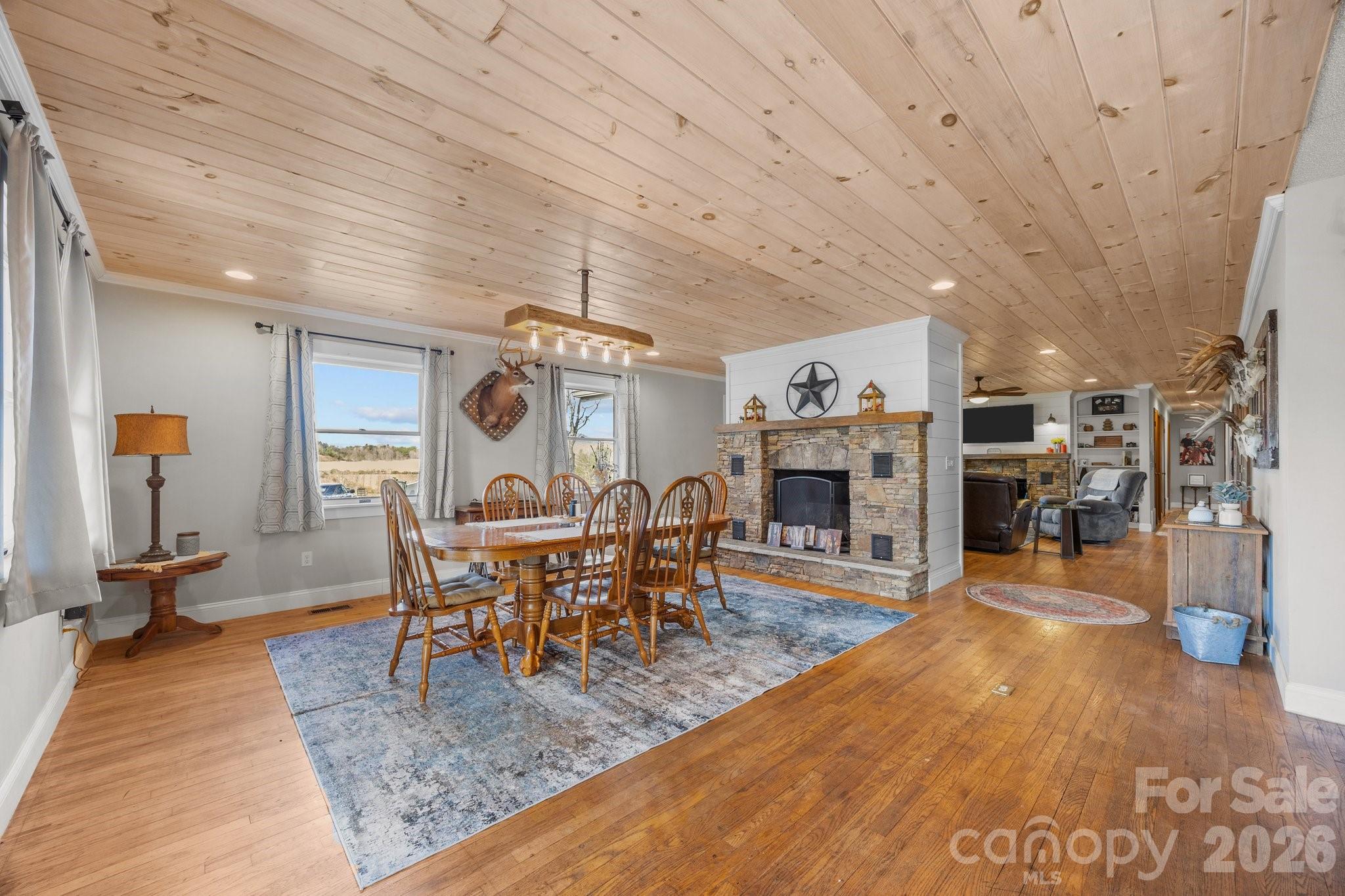 774 Belleview Road Franklin, NC 28734 - Photo 23 of 36 a dining room with wooden floor and a fireplace