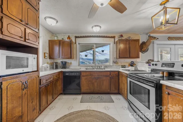 a kitchen with stainless steel appliances granite countertop a stove and a sink