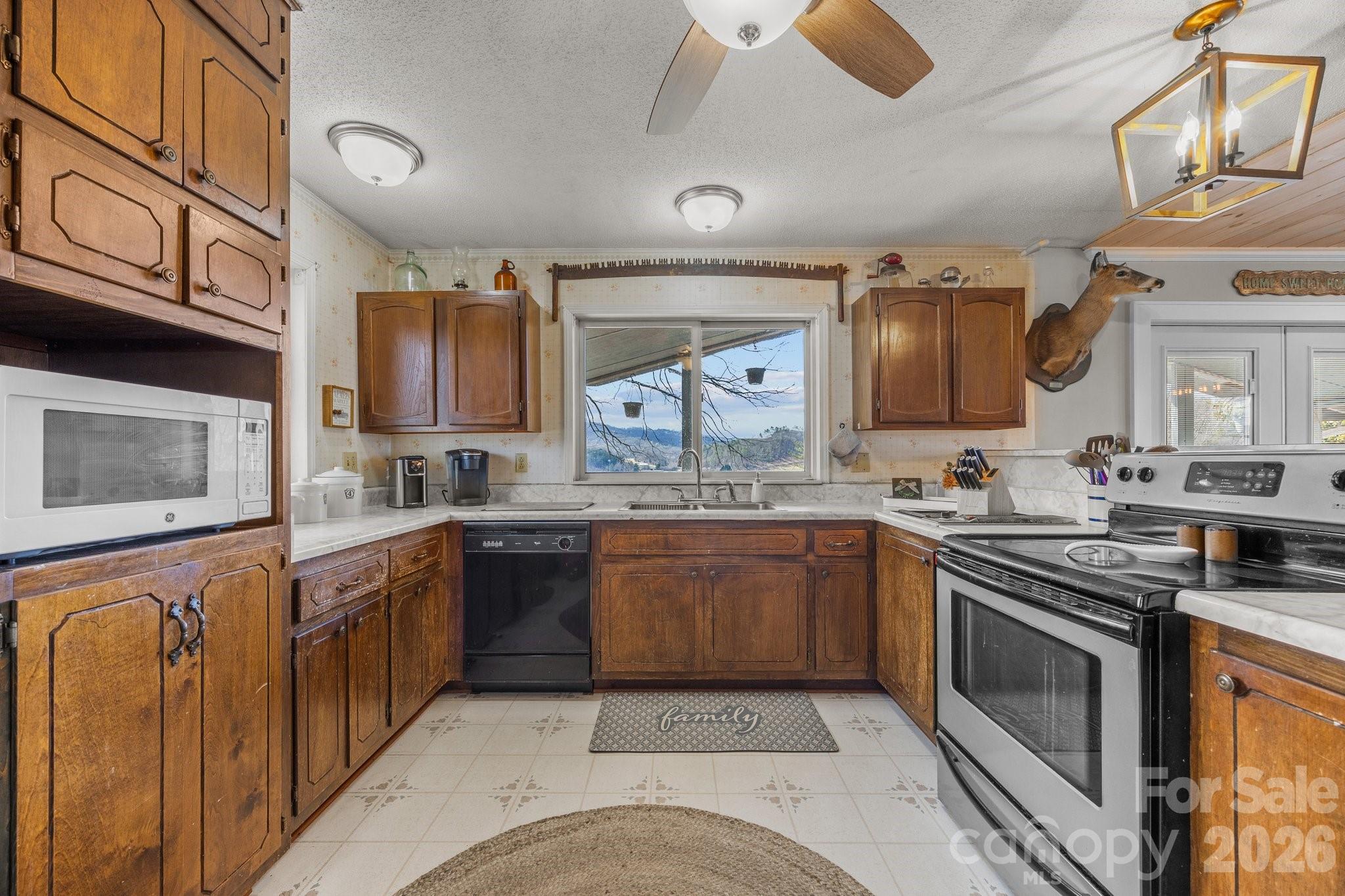 774 Belleview Road Franklin, NC 28734 - Photo 25 of 36 a kitchen with stainless steel appliances granite countertop a stove sink and cabinets