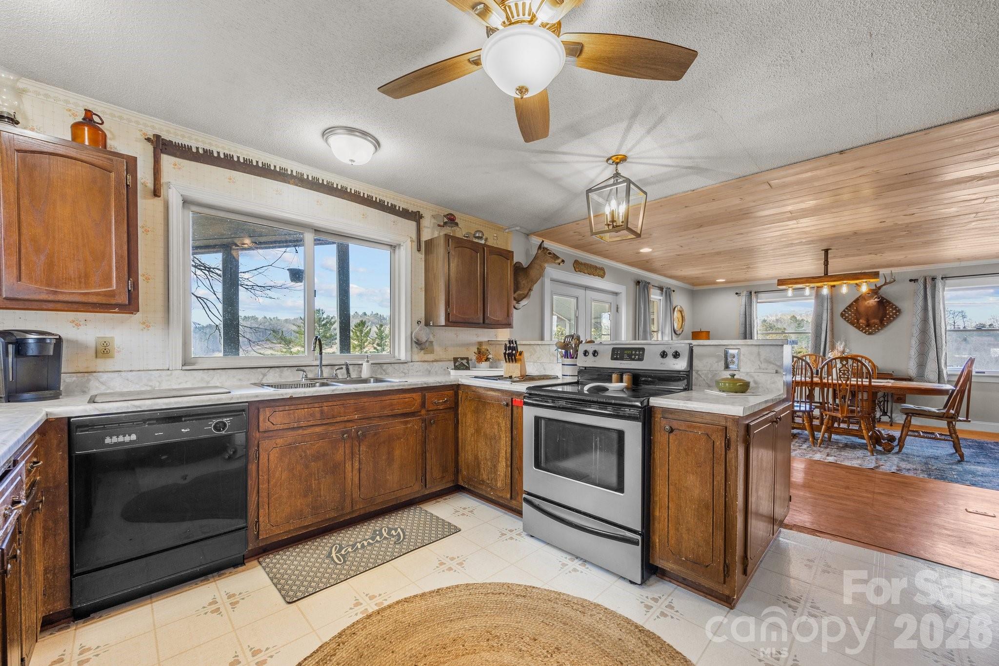 774 Belleview Road Franklin, NC 28734 - Photo 26 of 36 a kitchen with stainless steel appliances granite countertop a stove and a sink