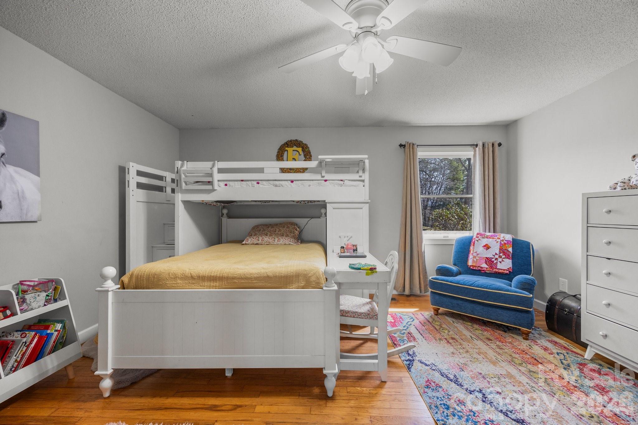 774 Belleview Road Franklin, NC 28734 - Photo 27 of 36 a bedroom with a bed and wooden floor