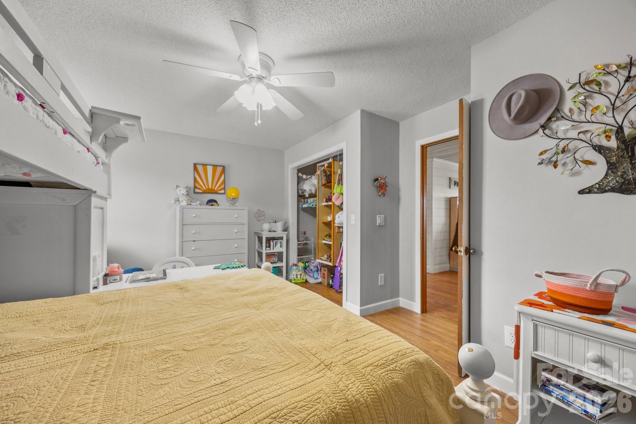 774 Belleview Road Franklin, NC 28734 - Photo 28 of 36 a bedroom with a bed and a chandelier