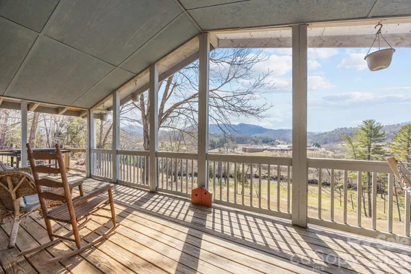 a balcony view with a seating space