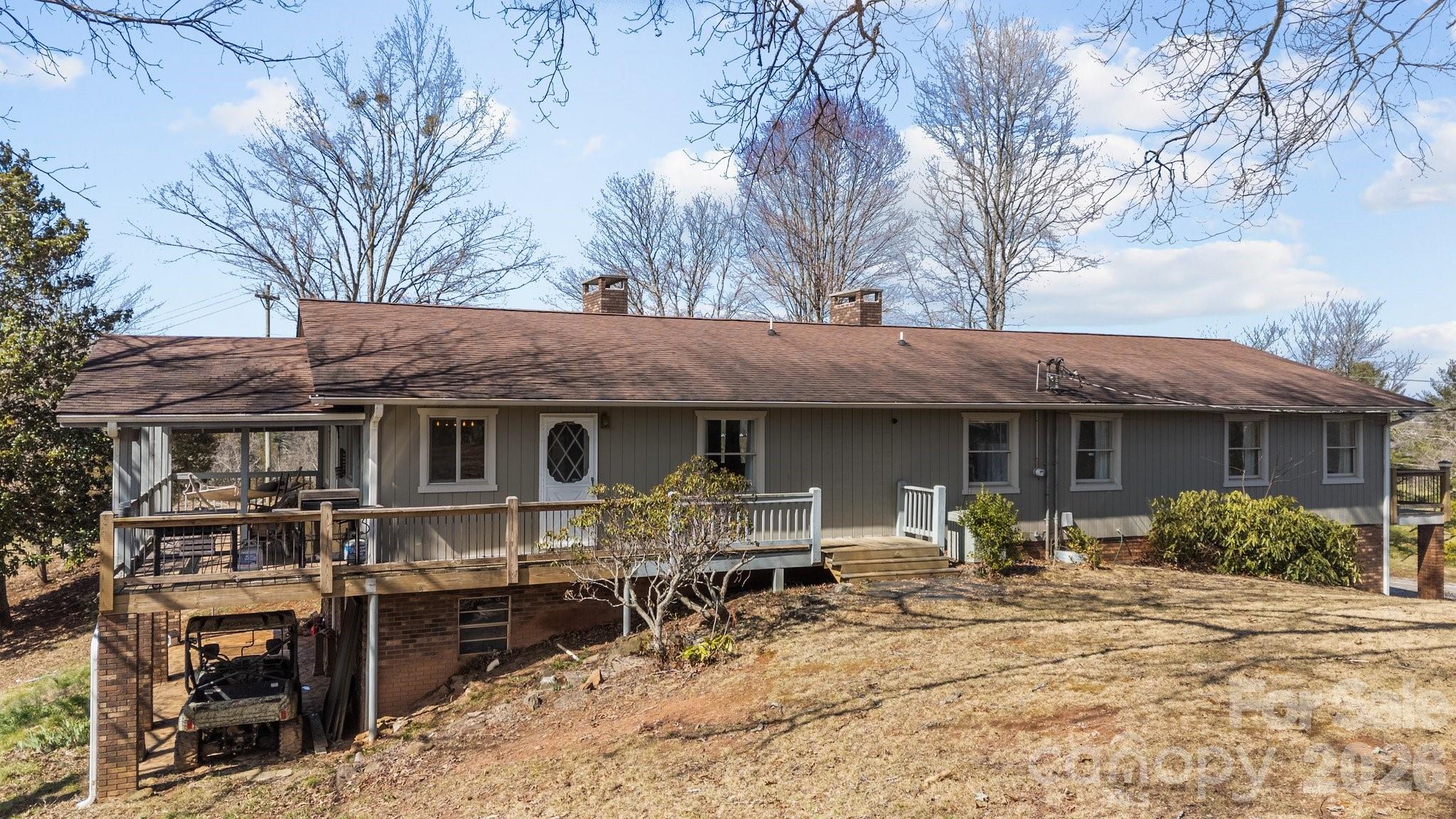 774 Belleview Road Franklin, NC 28734 - Photo 4 of 36 a front view of a house with table and chairs under an umbrella