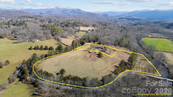 an aerial view of a swimming pool with a mountain