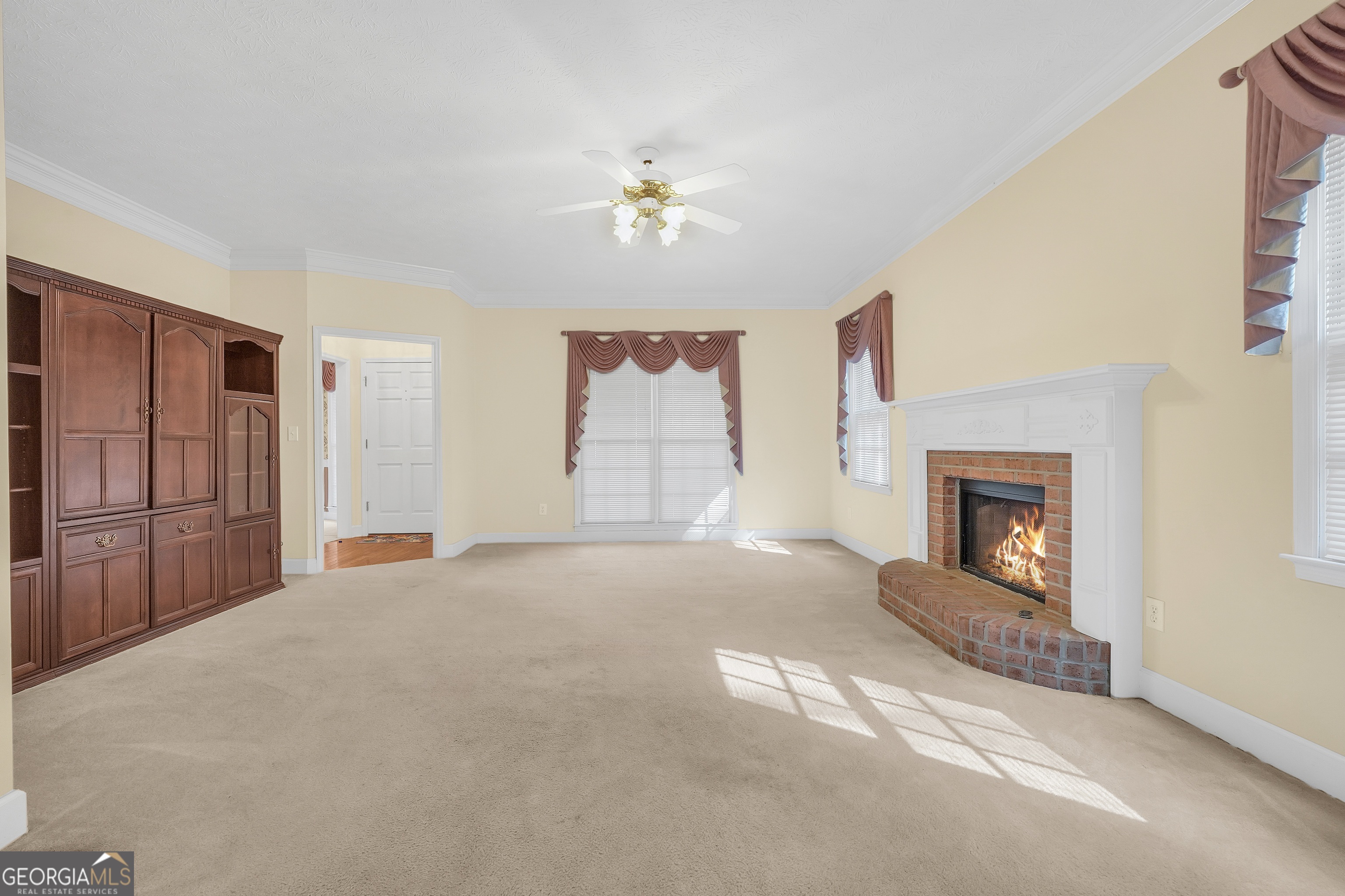 2141 South River Road Southwest Conyers, GA 30094 - Photo 18 of 54 a living room with furniture a chandelier and a fireplace