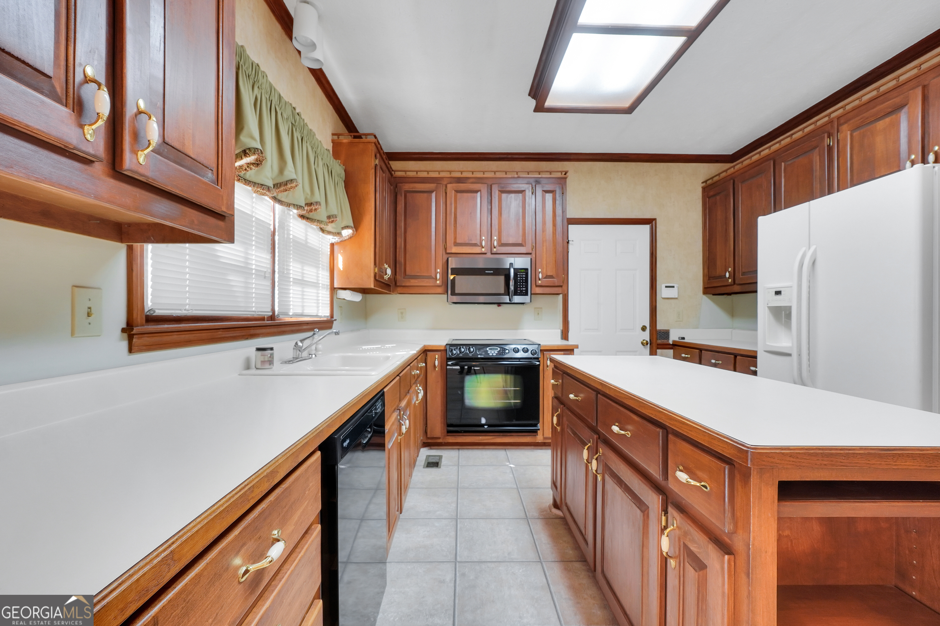 2141 South River Road Southwest Conyers, GA 30094 - Photo 22 of 54 a kitchen with stainless steel appliances granite countertop a sink and a refrigerator