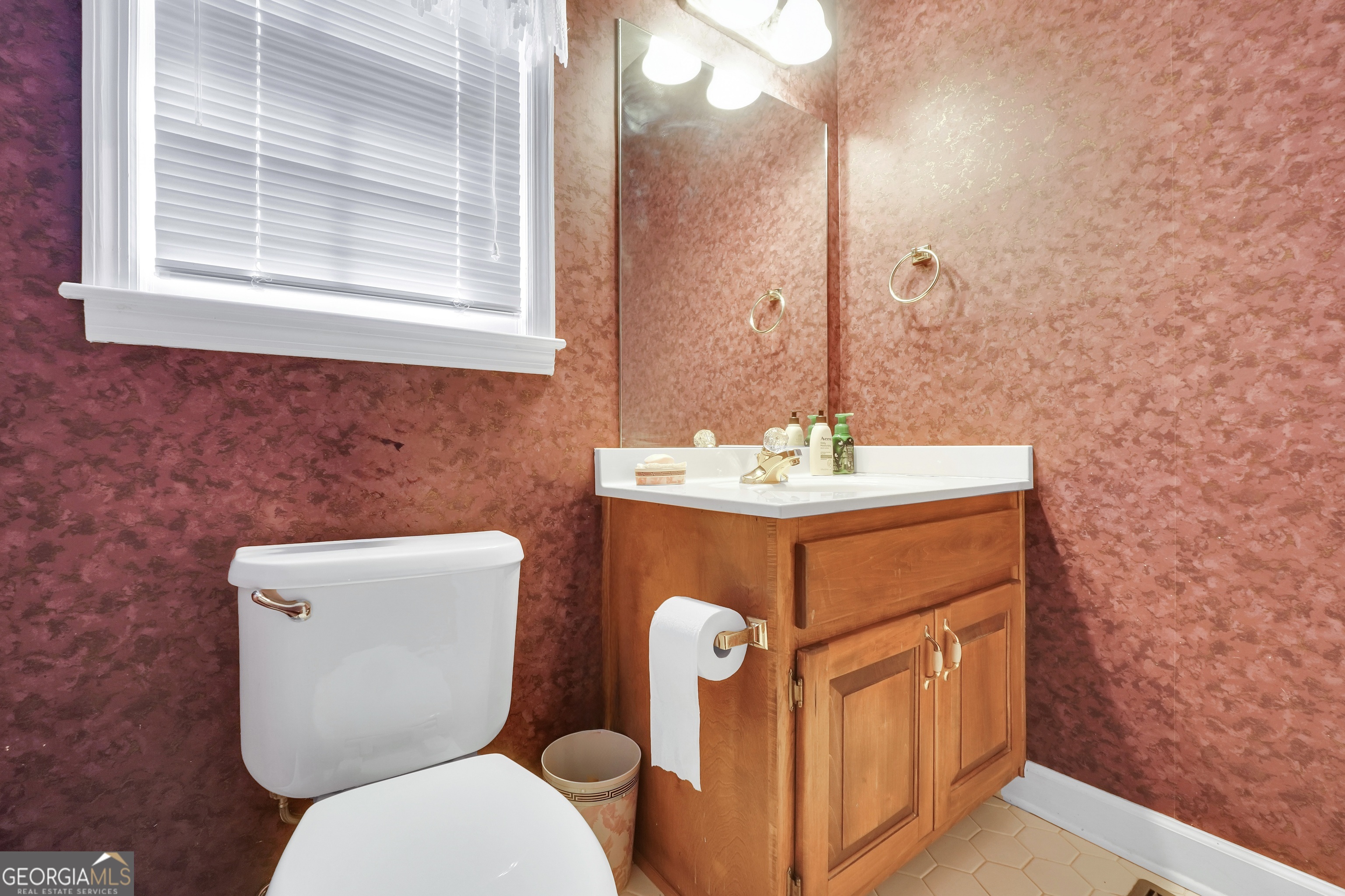 2141 South River Road Southwest Conyers, GA 30094 - Photo 27 of 54 a bathroom with a toilet sink and mirror