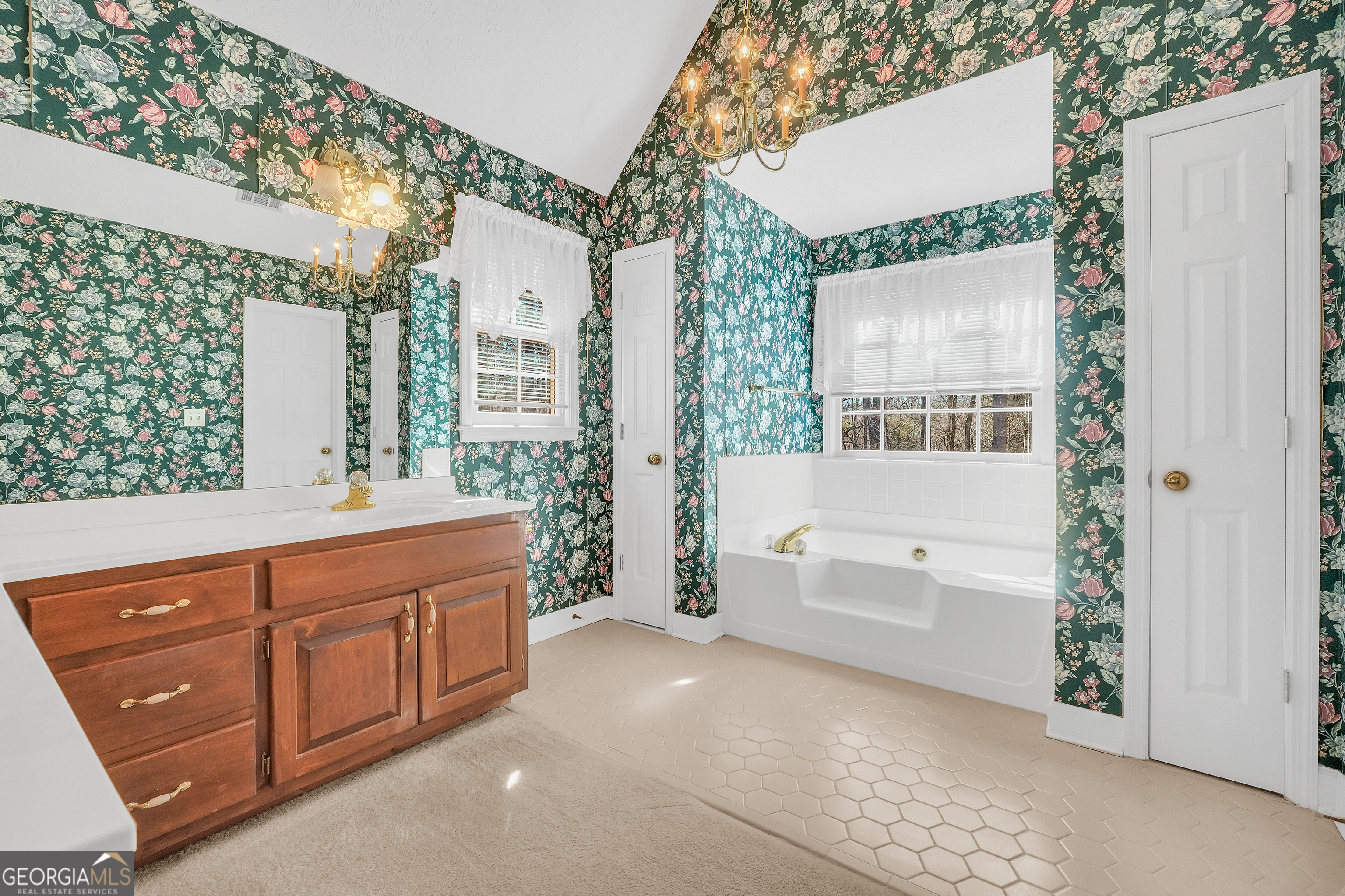 2141 South River Road Southwest Conyers, GA 30094 - Photo 33 of 54 a bathroom with a tub a sink and a large mirror