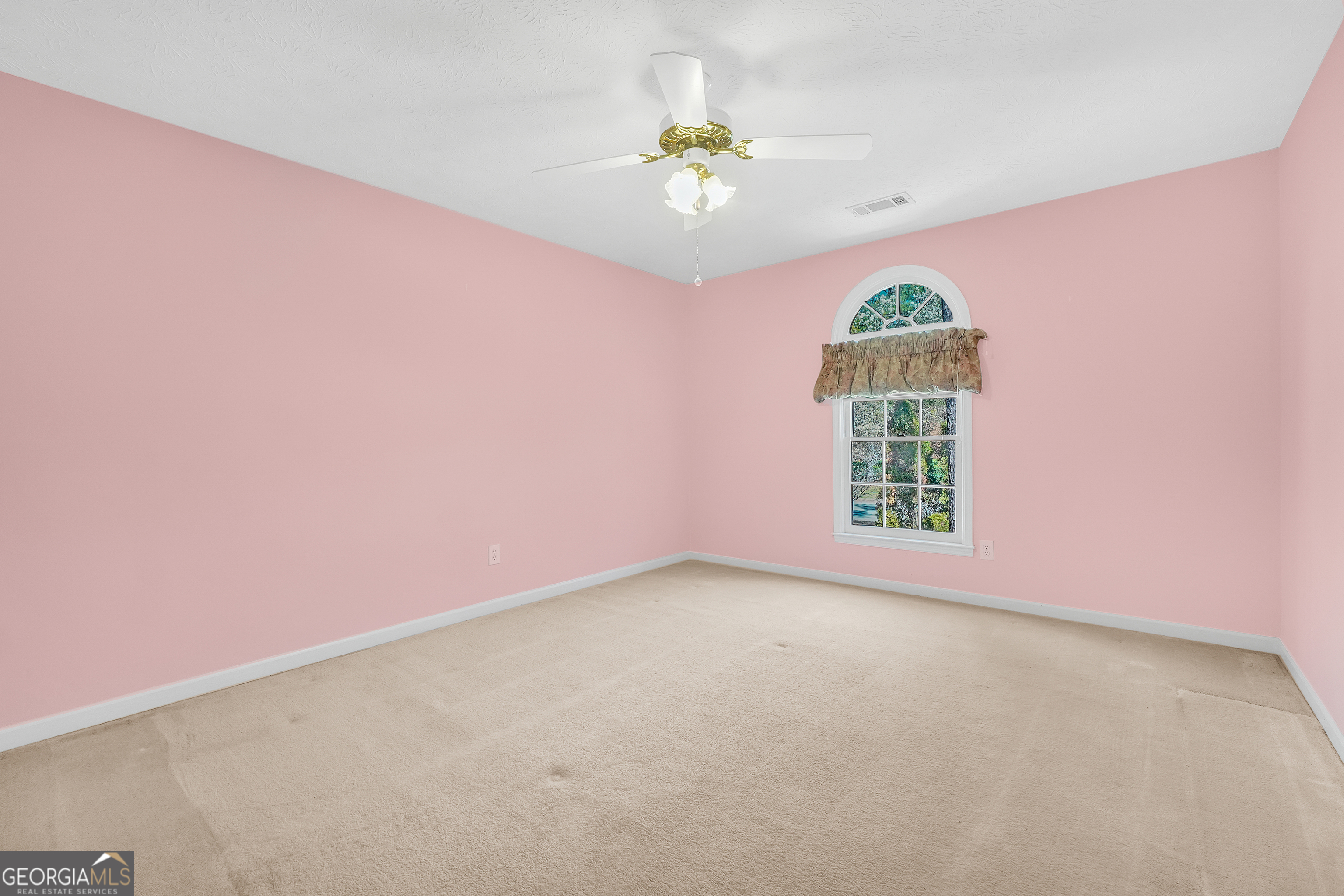 2141 South River Road Southwest Conyers, GA 30094 - Photo 36 of 54 an empty room with a chandelier fan and windows