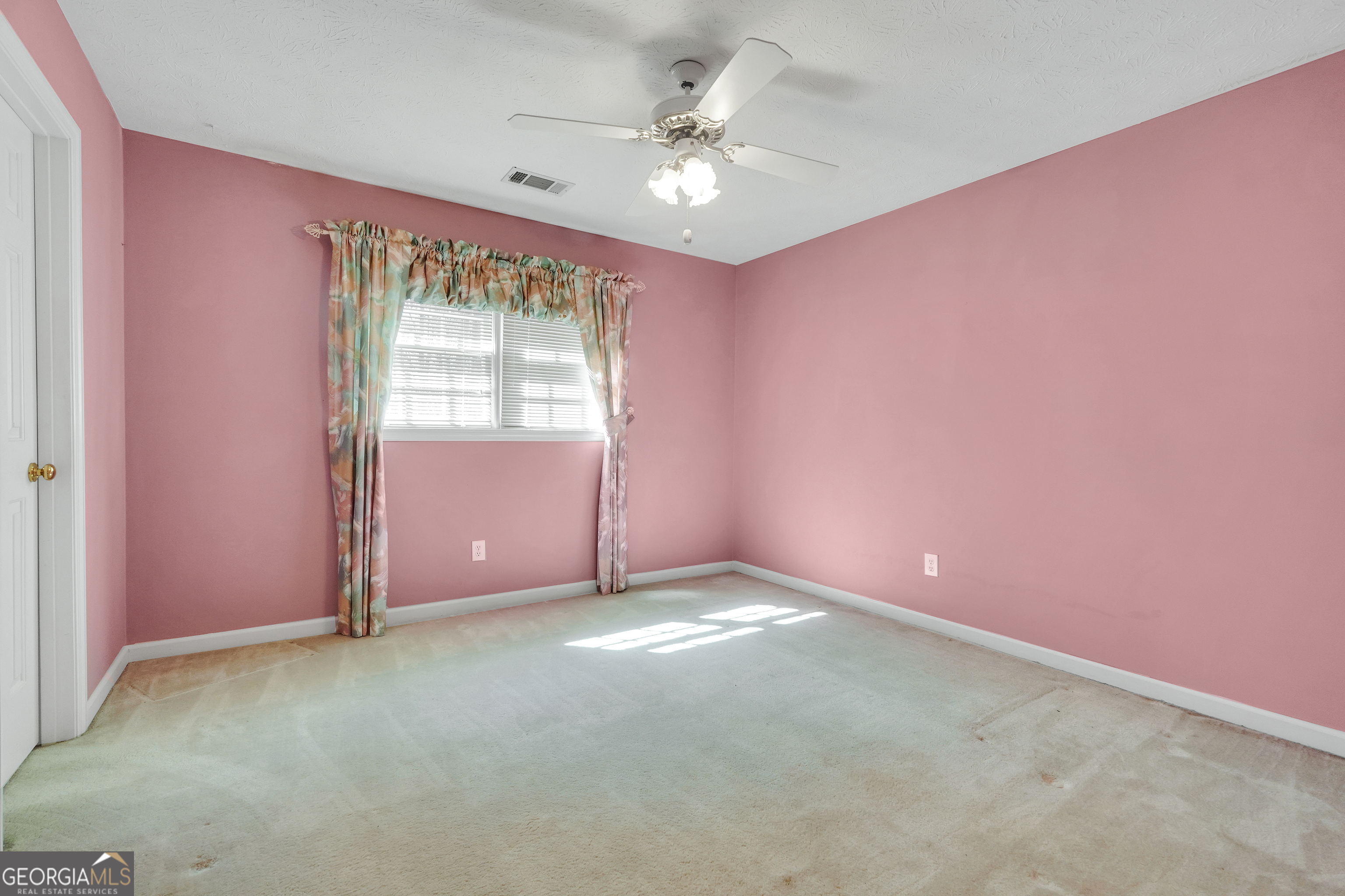 2141 South River Road Southwest Conyers, GA 30094 - Photo 38 of 54 an empty room with windows and fan