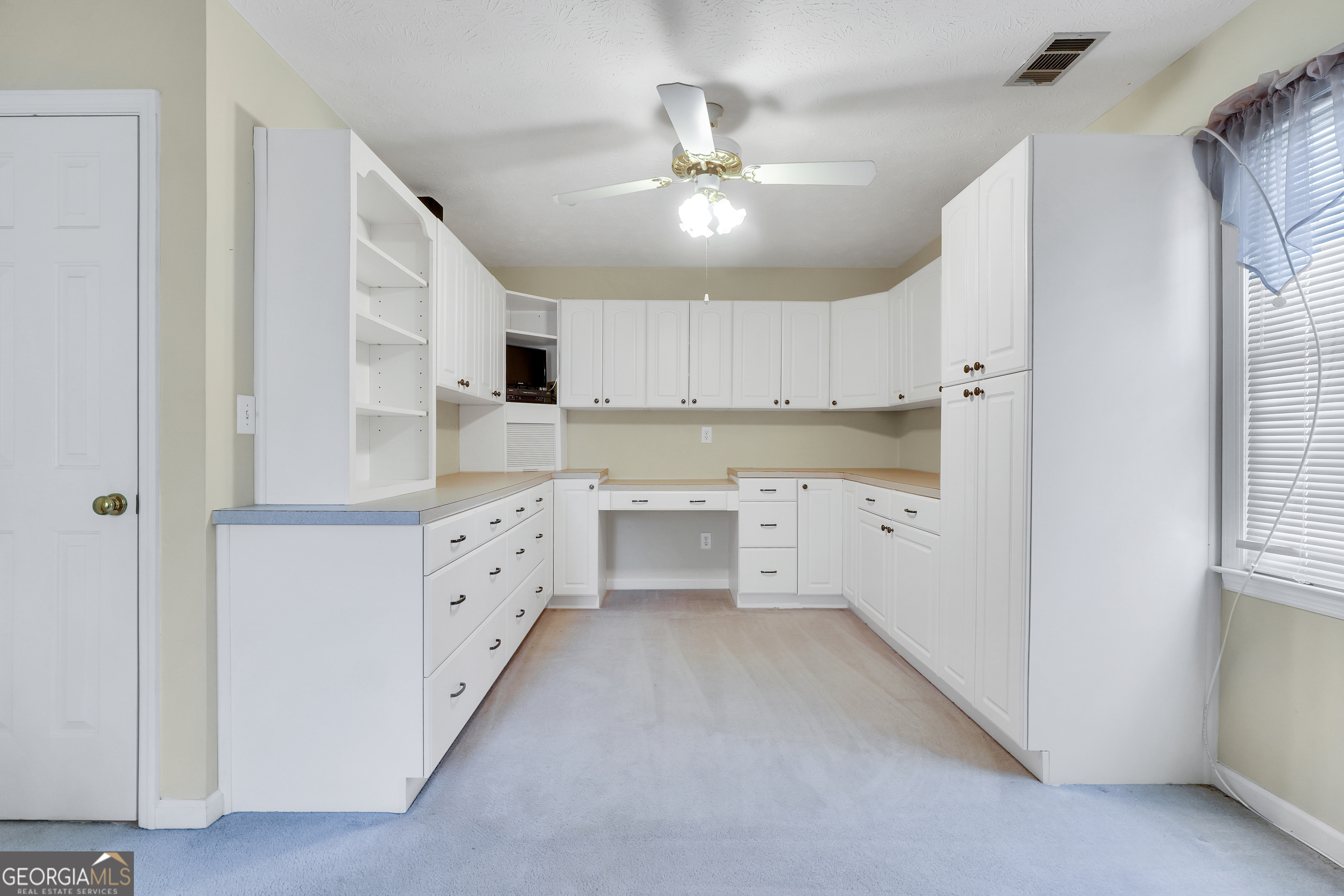 2141 South River Road Southwest Conyers, GA 30094 - Photo 43 of 54 a large white kitchen with cabinets
