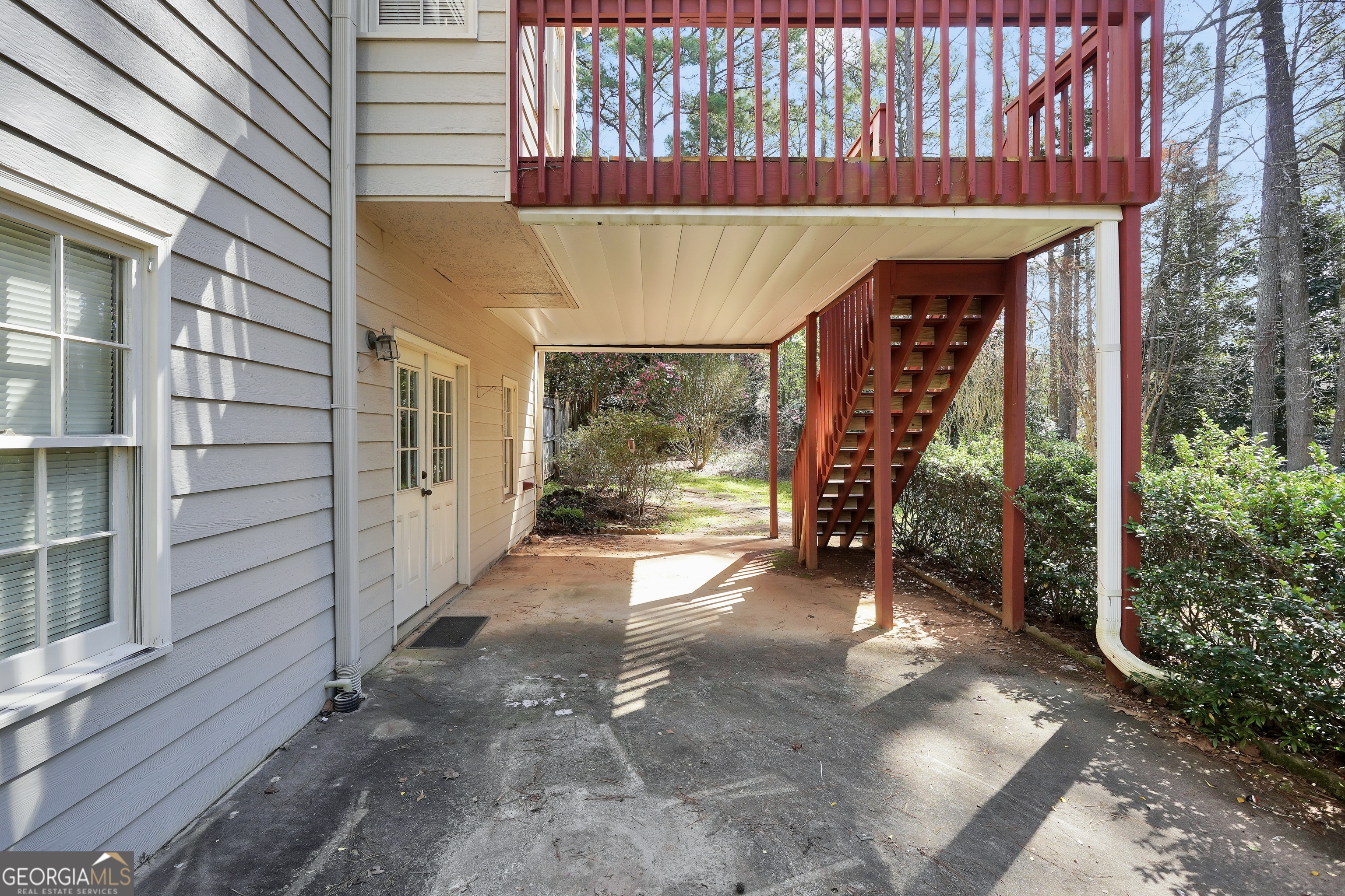 2141 South River Road Southwest Conyers, GA 30094 - Photo 6 of 54 a view of a patio with table and chairs and floor to ceiling window and wooden fence