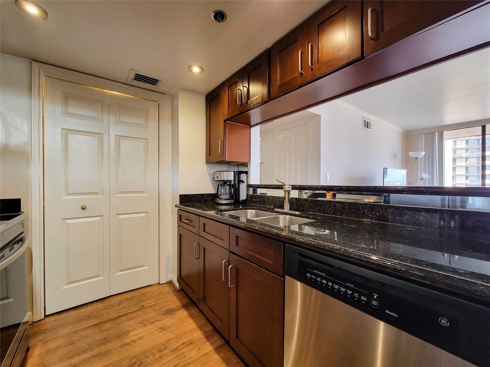 3525 Sage Road, Unit 1605 Houston, TX 77056 - Photo 9 of 33 a kitchen with stainless steel appliances granite countertop a sink and wooden cabinets