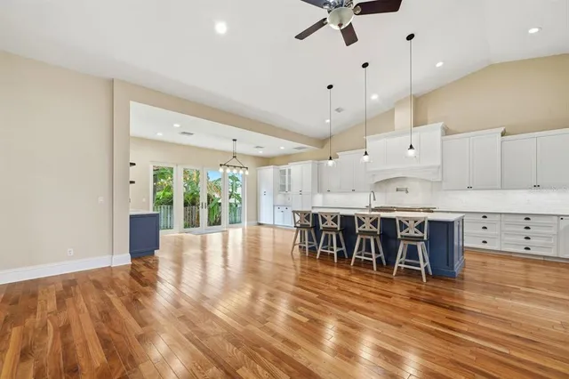 a large kitchen with cabinets a sink and a stove