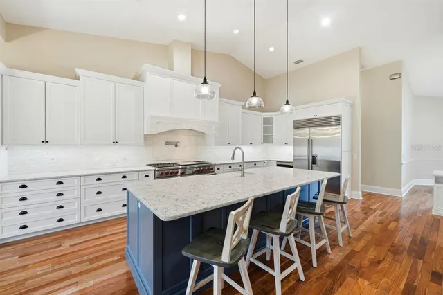 a kitchen with kitchen island a sink counter top space and stainless steel appliances