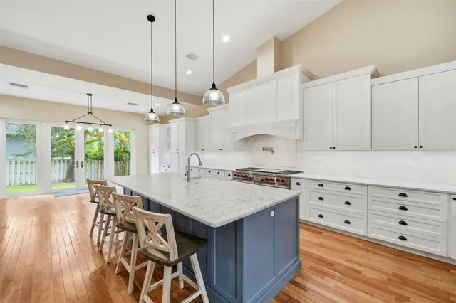 a kitchen with stainless steel appliances white cabinets and a stove