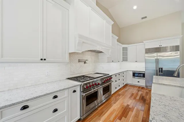 a kitchen with cabinets and stainless steel appliances