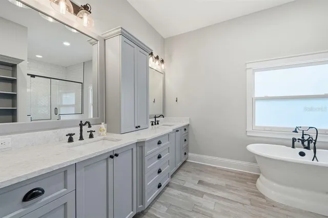 a view of bathroom with a tub and shower