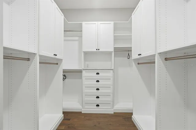 a bathroom with a granite countertop sink a toilet and bathtub