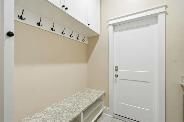 a backyard of a house with plants and tree