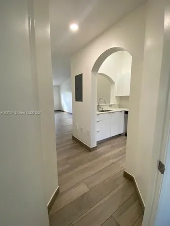 an empty room with wooden floor and a window