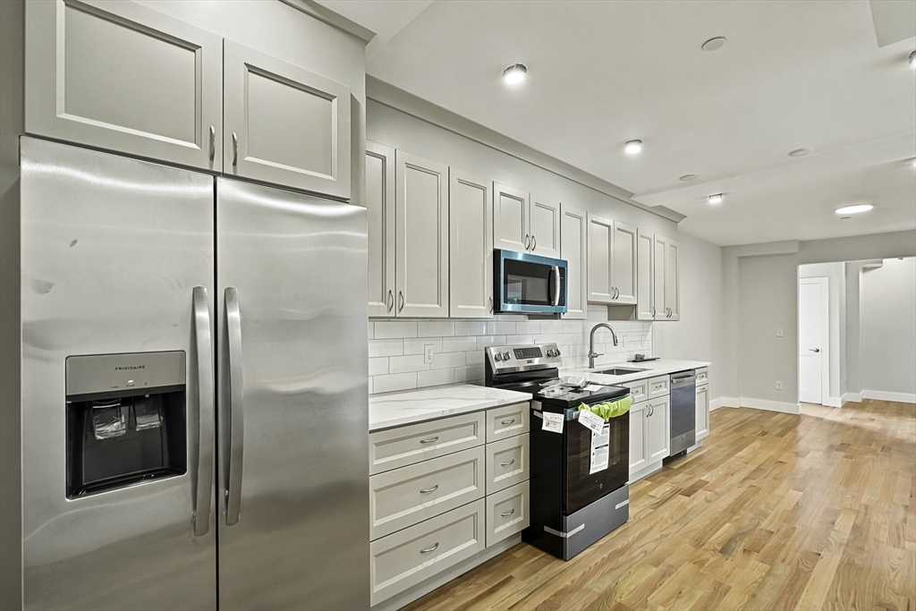 4 Mayhew Street Framingham, MA 01702 - Photo 6 of 42 a kitchen with stainless steel appliances a refrigerator sink and cabinets