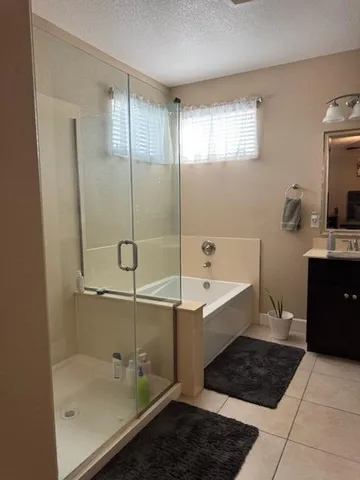 a bathroom with a bathtub and a shower