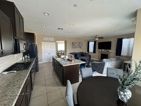 a kitchen with stainless steel appliances granite countertop a sink a stove counter space and cabinets