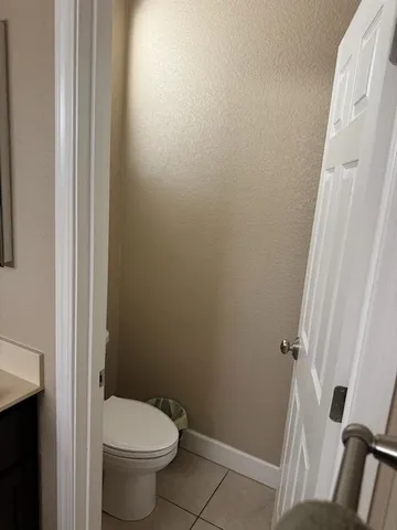 a white toilet sitting next to a shower