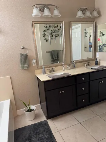 a bathroom with a double vanity sink mirror and