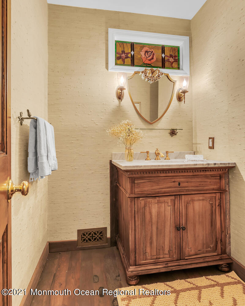 122 Browns Dock Road Middletown, NJ 07716 - Photo 32 of 54 a bathroom with a sink a mirror and a shower